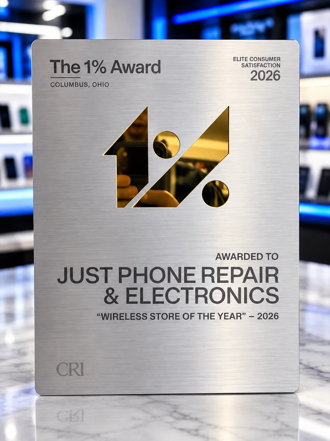 Brushed-metal plaque reading The 1% Award, Columbus, Ohio, Elite Consumer Satisfaction 2026, awarded to Just Phone Repair & Electronics, Wireless Store of the Year, 2026.